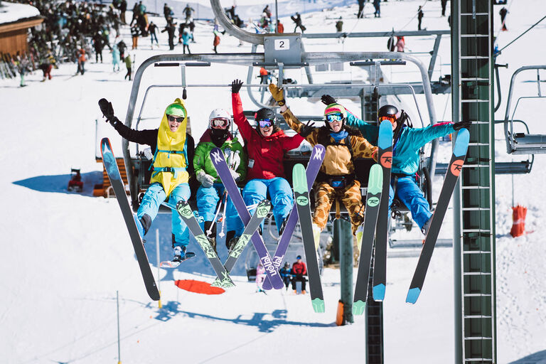SheJumps participants posing for a happy picture on the chairlift