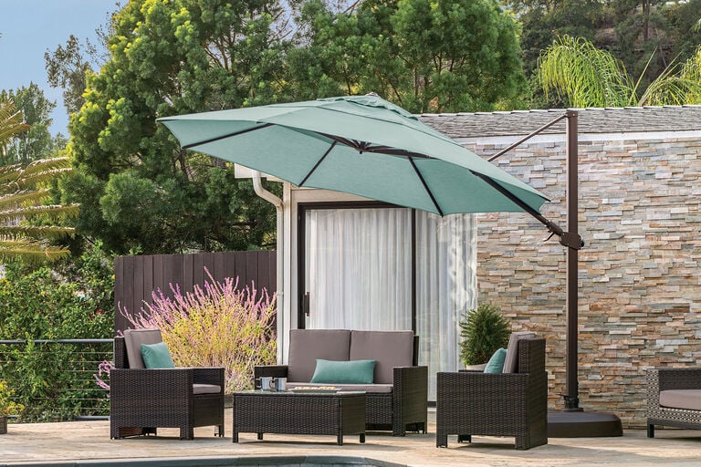 Cantilever umbrella covering patio furniture