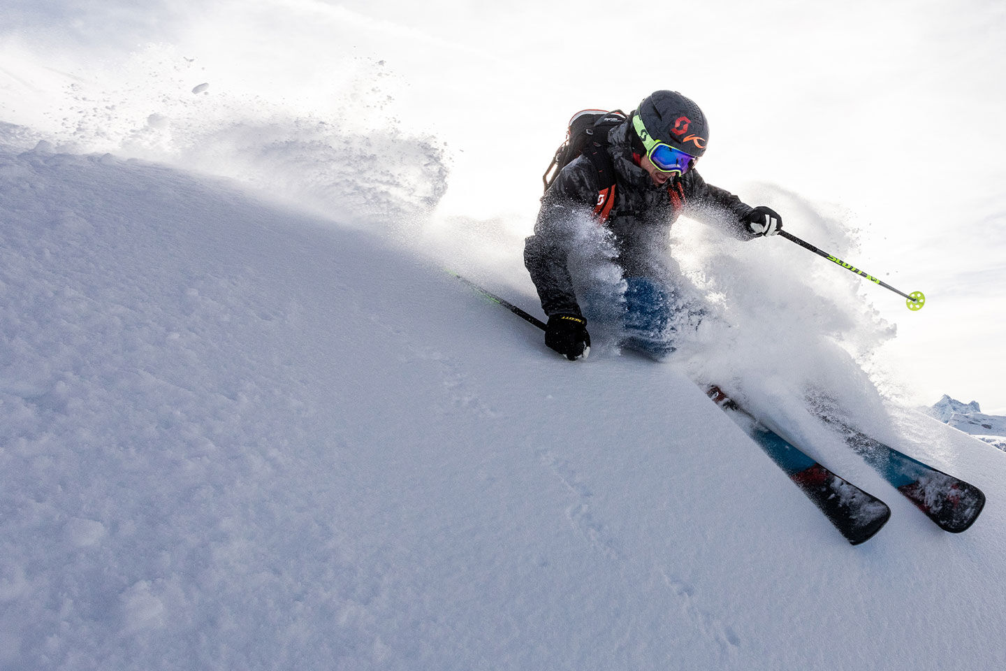 Skier shredding through a pow field