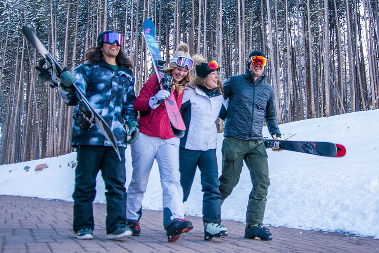 Group of skiers walking and laughing 