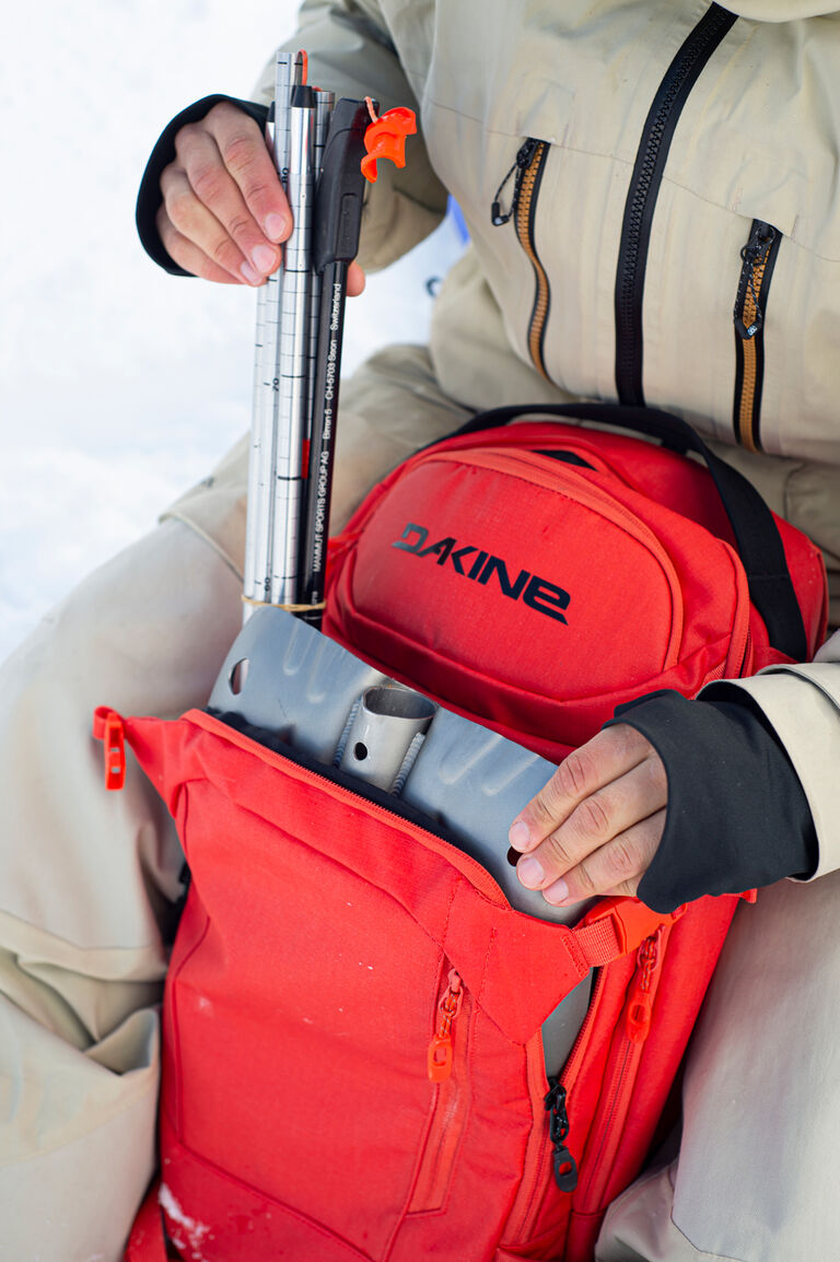 backpack packed with a beacon shovel and probe