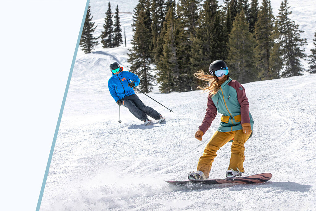 Skier and snowboarder on a groomer