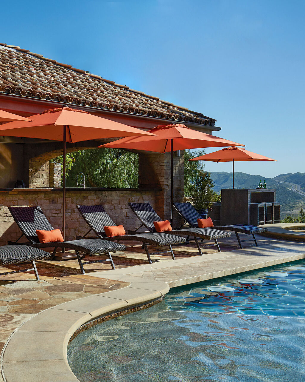 commercial patio furniture series of chaise lounges with umbrellas poolside