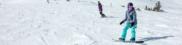 two snowboarders on a slope two snowboarders on a slope