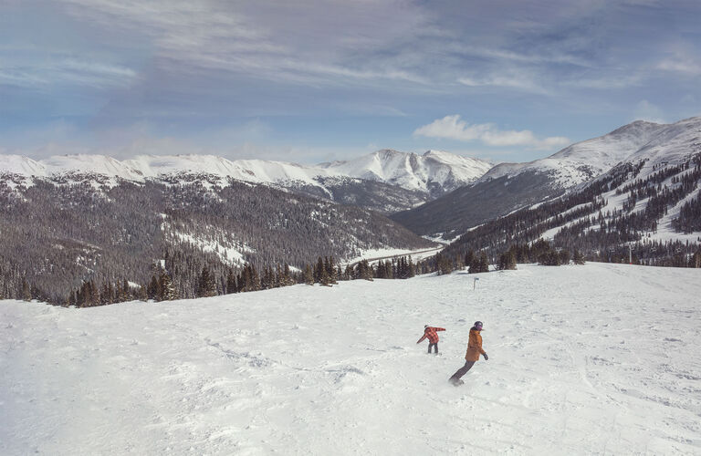 skiers walking across the hill