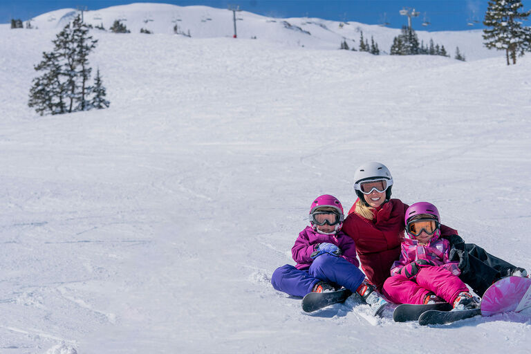 family smiling sitting on mountain
