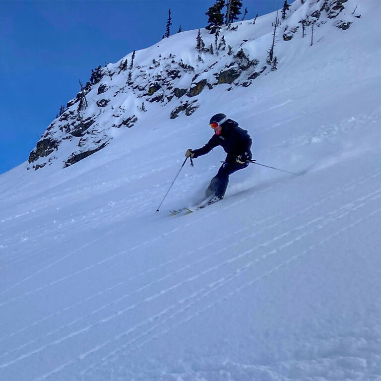 Anna H skiing on a steep powder slope
