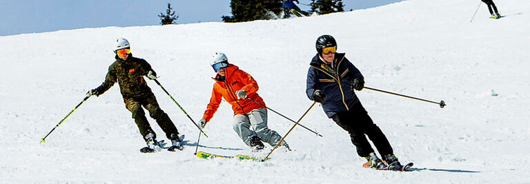 Tracy skiing with friends on a sunny day