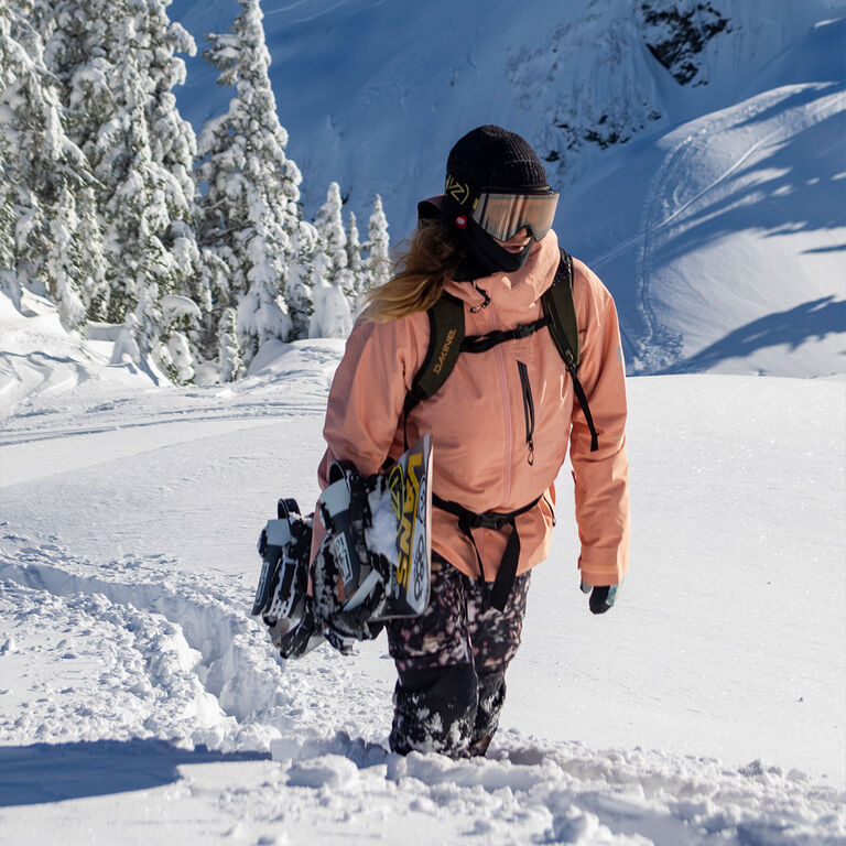 Snowboarder hiking uphill