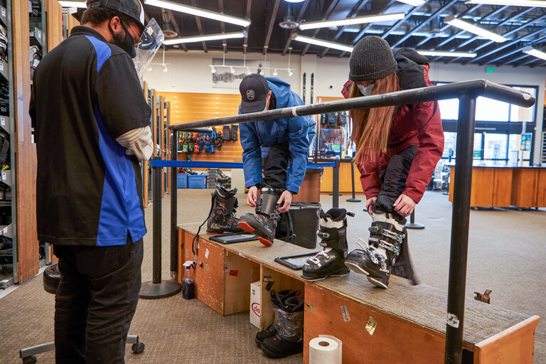 Couple picking up ski rentals at Christy Sports