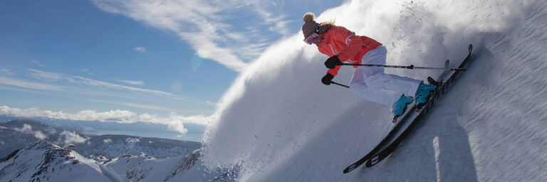 Woman skiing steep powder
