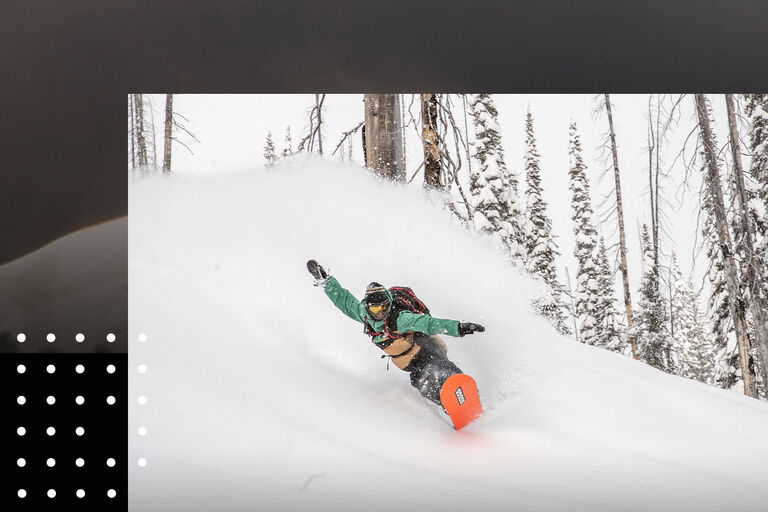 snowboarder riding powder