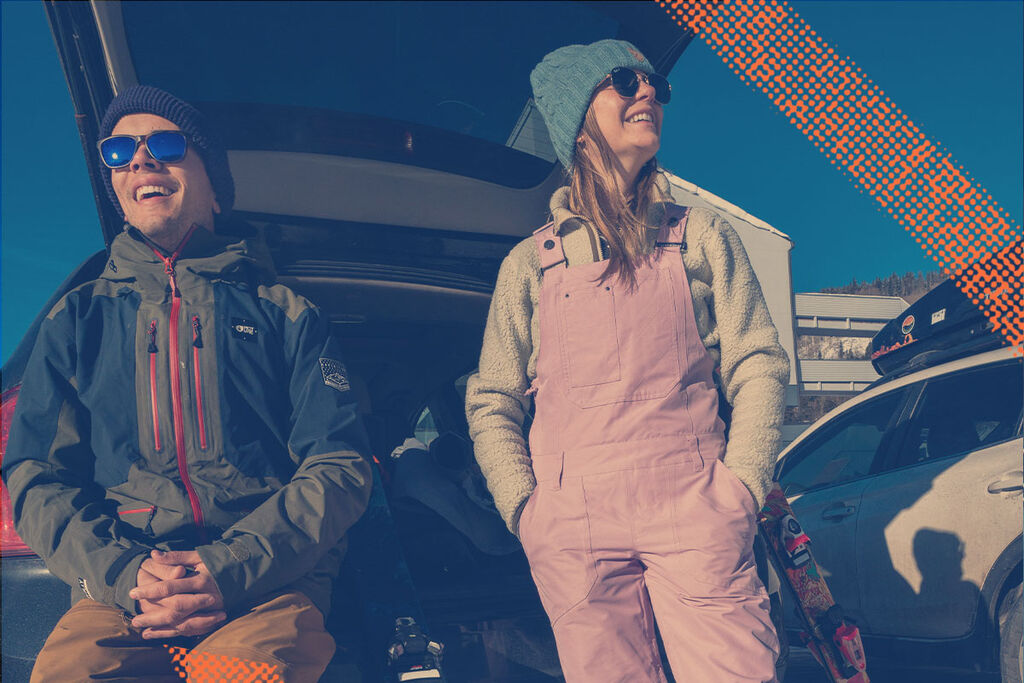 Two skiers chilling in the parking lot
