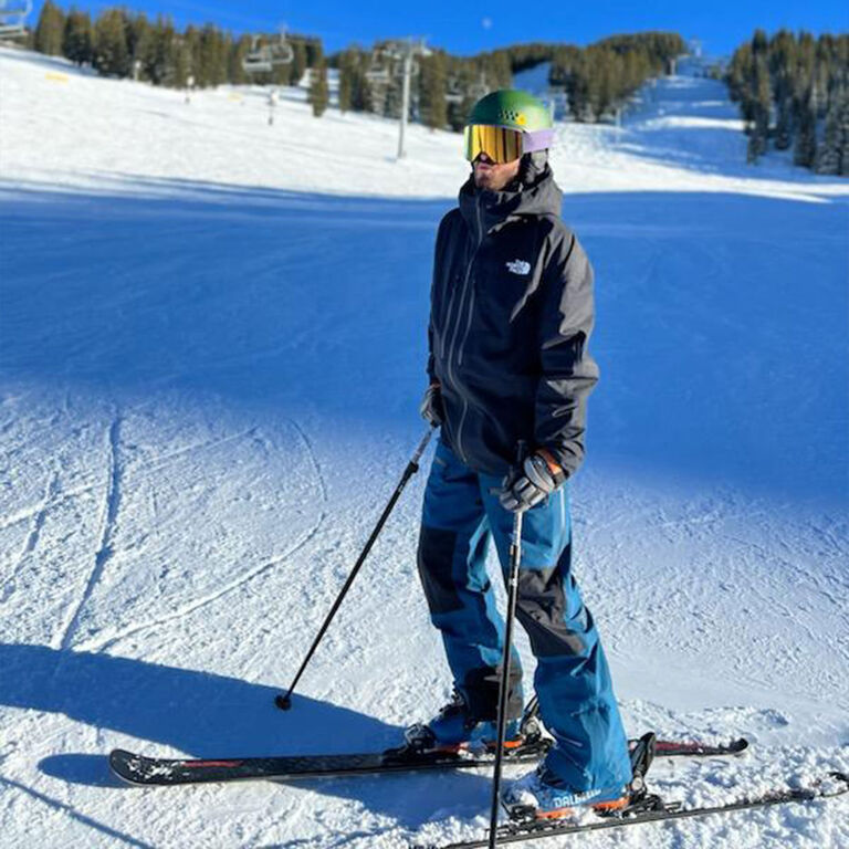 Jay R wearing ski gear standing on a ski run