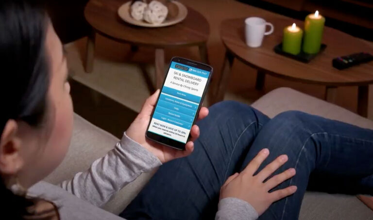 Woman using phone to reserve rentals online