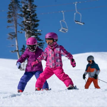 three kids skiing