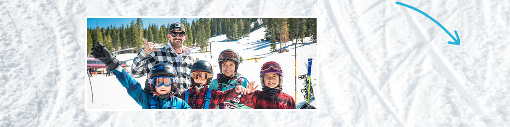 kids in ski gear on slopes smiling