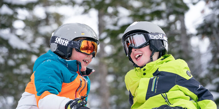 kids in snow gear smiling