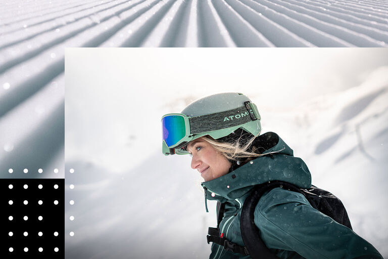 woman in ski gear looking at a winter landscape