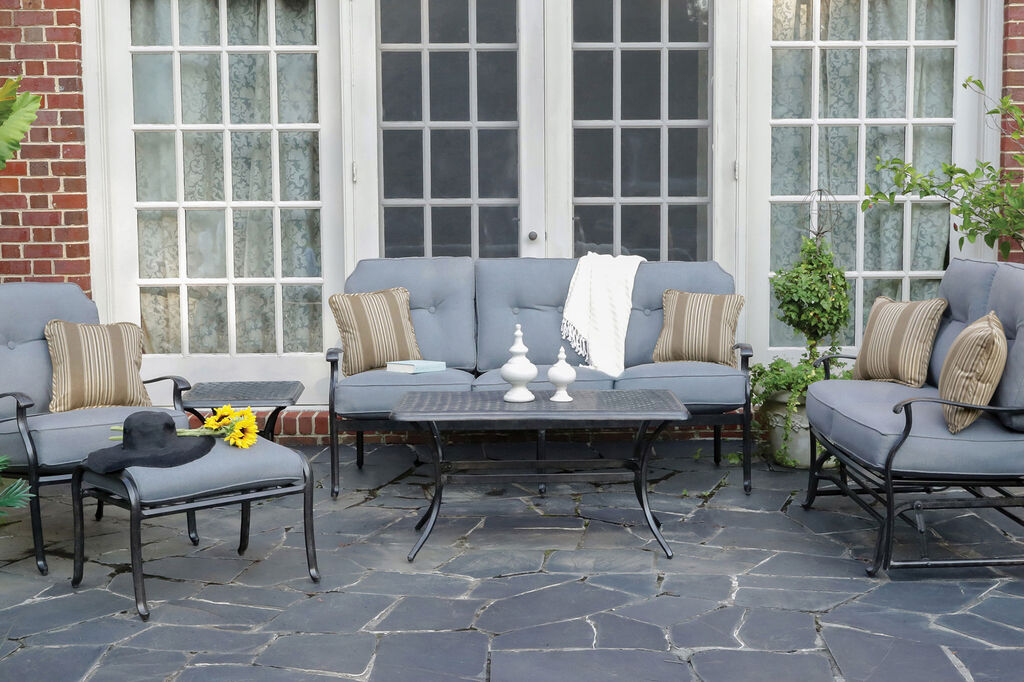 Madison by Apricity lounge furniture with coffee table on gray stone patio