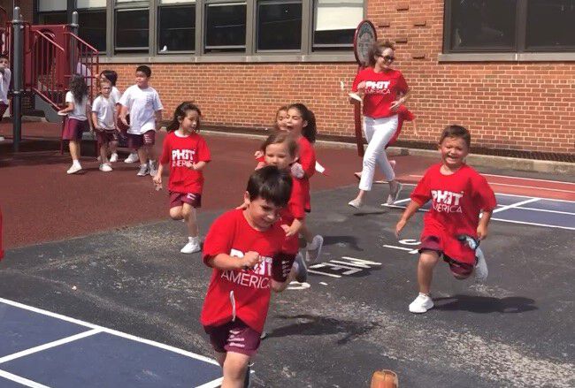 Kids playing on a basketball court
