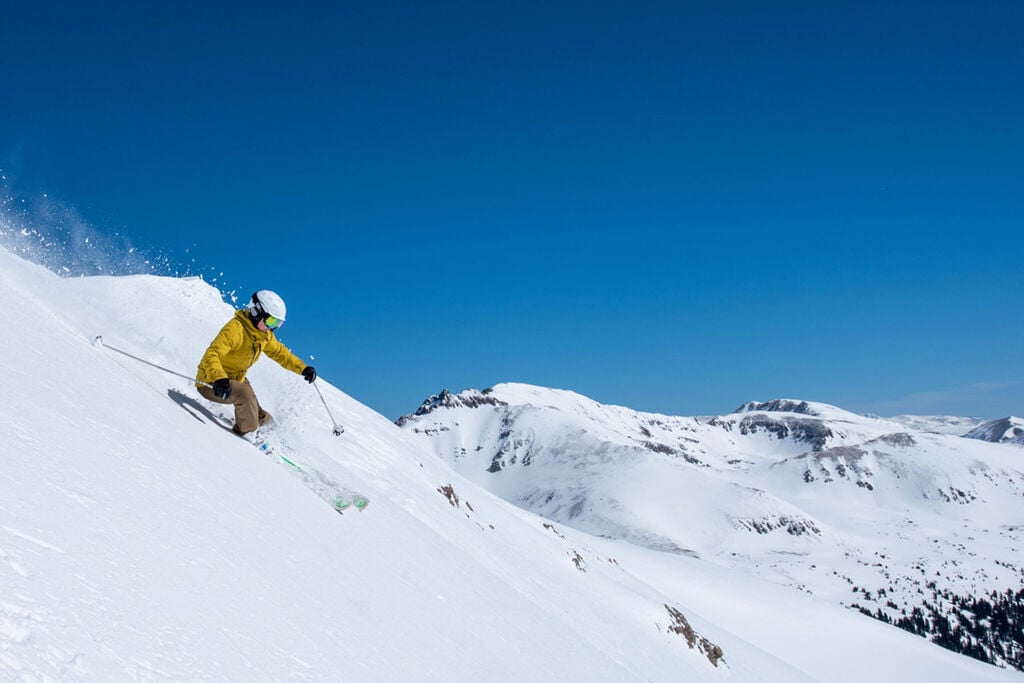 skier shredding down the mountain