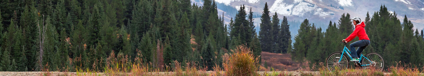 woman riding bike on mountain trail