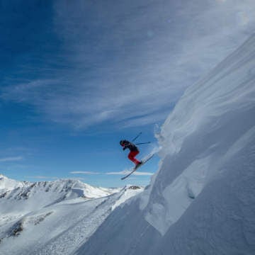 skier catching air off a cornice