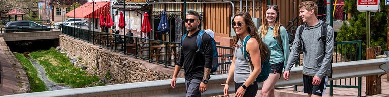 Group of people outside walking through a mountain town