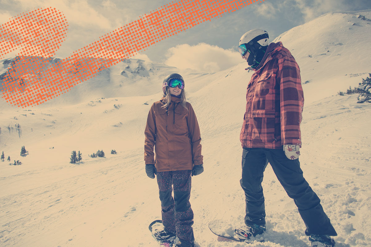 two snowboarders chatting on the slope