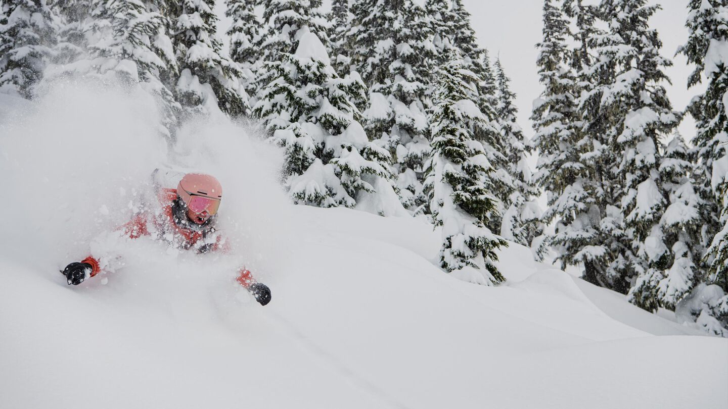 Woman skiing in super deep powder
