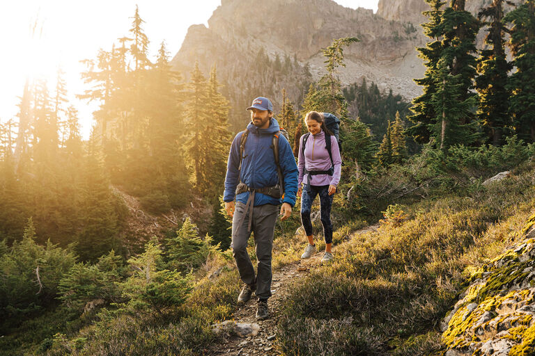 Two adults outside hiking in the mountains